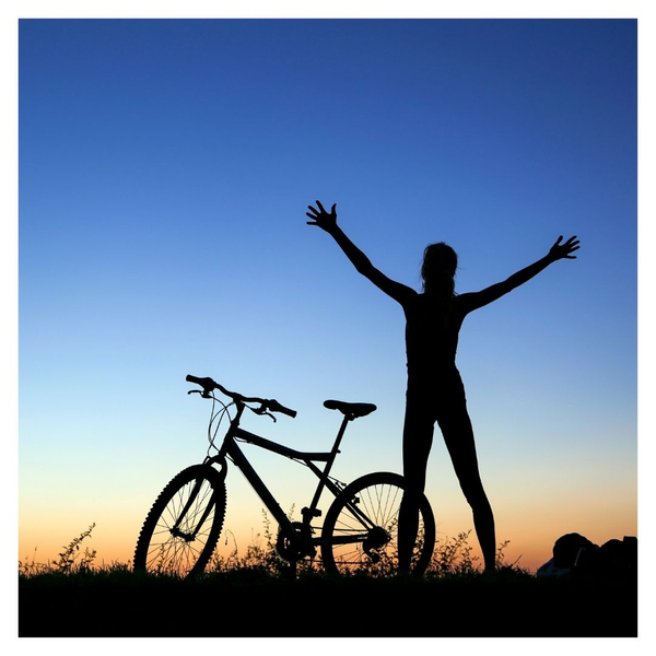 person riding bike at sunset