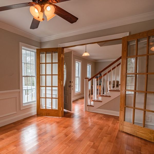 interior room with trim and wooden doors
