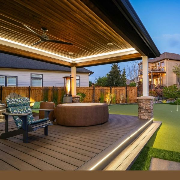 large new porch, with underlighting and a large circular furniture - hot tub maybe