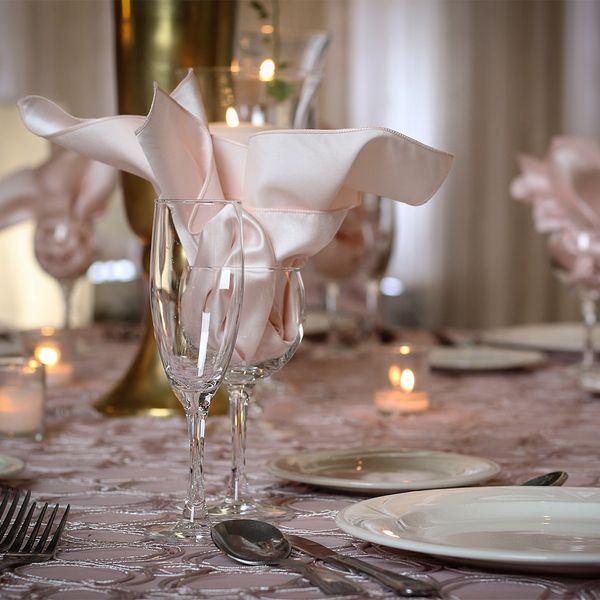 Pink napkins in wine and champagne glasses