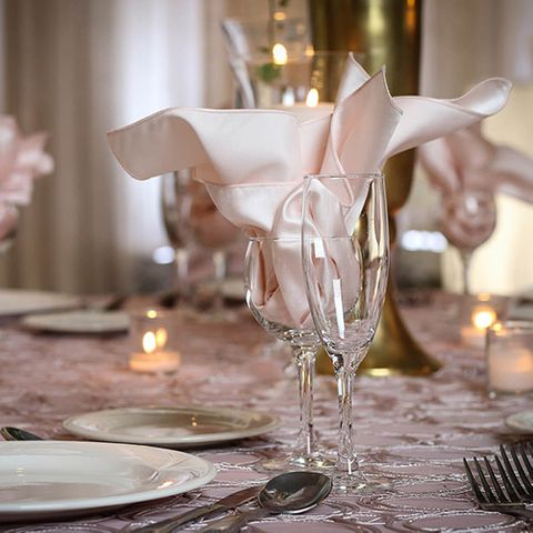 Pink napkins in wine and champagne glasses