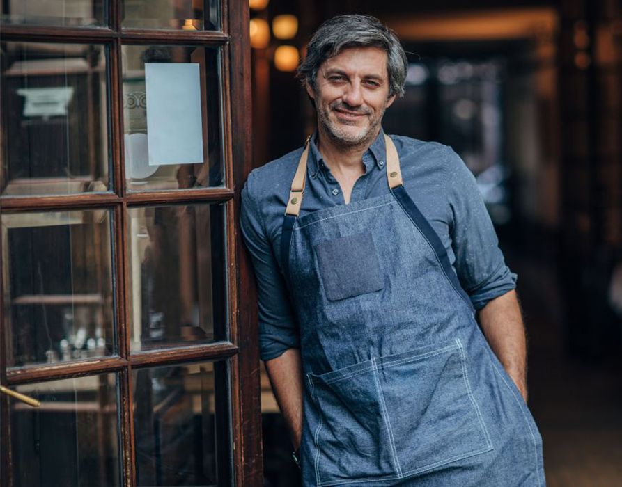 Man smiling with apron