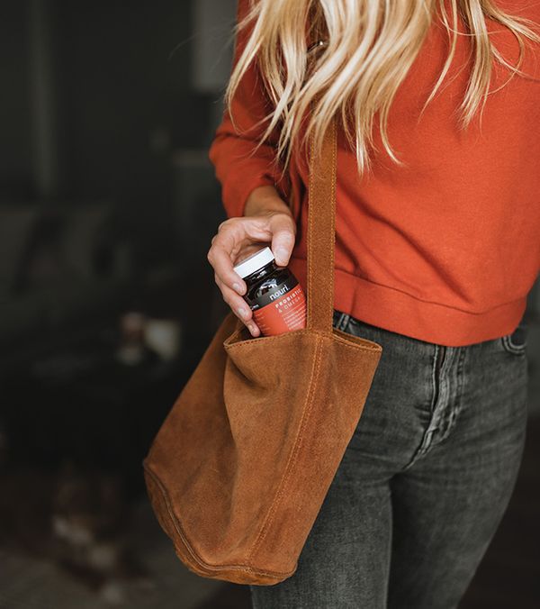 A woman putting supplements in her bag