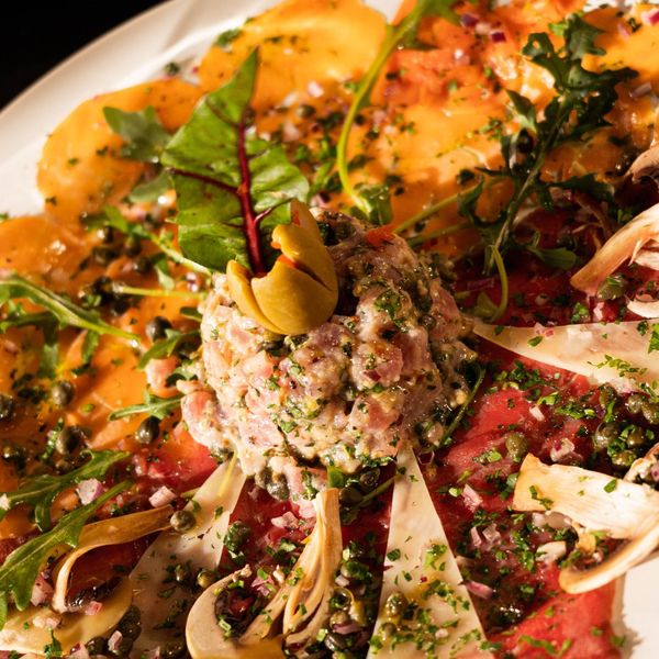 a close-up of a plate of CARPACCIO BRUNETTA