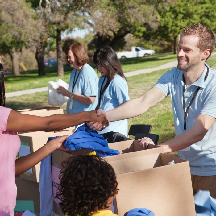a group of volunteers handing out donations