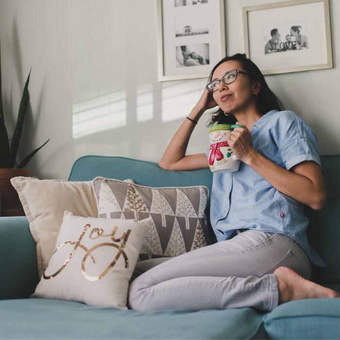 Woman relaxing on the couch in her newly decluttered space