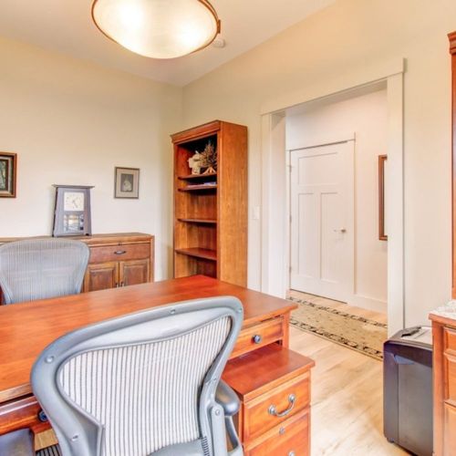 Home office space with desk and bookshelves   