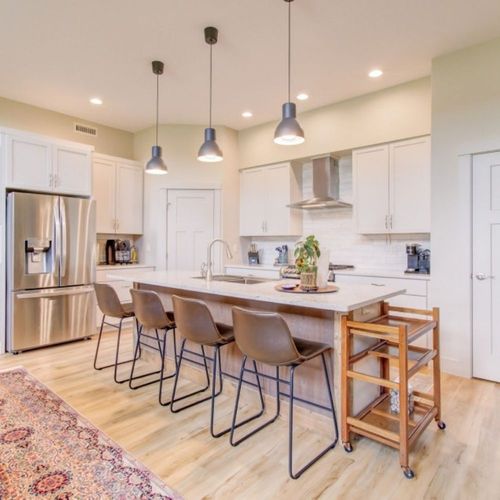 Modern kitchen with island seating and warm lighting