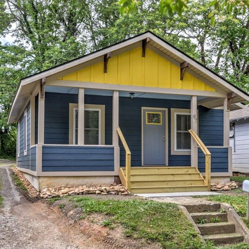 Blue cottage with yellow trim and porch steps