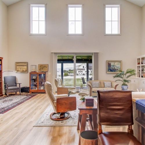 Bright living room with high windows and hardwood floors