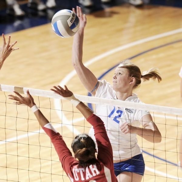 women playing competitive volleyball