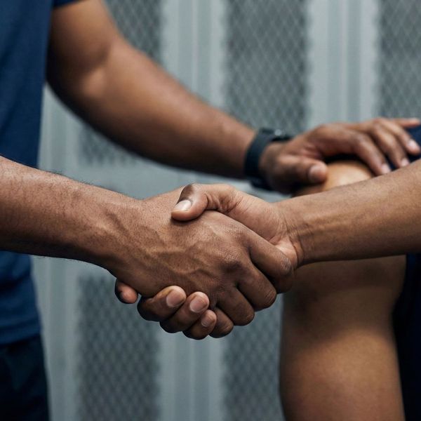Close-up of a handshake symbolizing successful conflict resolution and trust building.