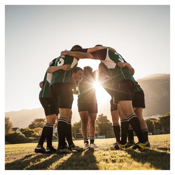 mens soccer team in a huddle