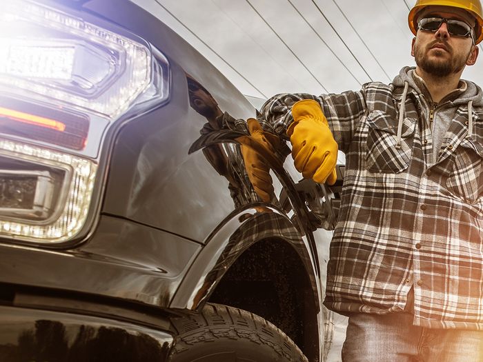  Image of a man standing next to his truck. 