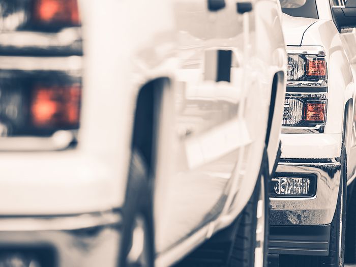   Image of pickup trucks driving in a line. 