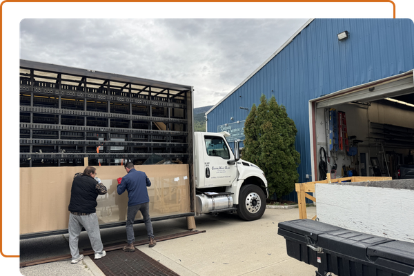 team loading glass onto truck