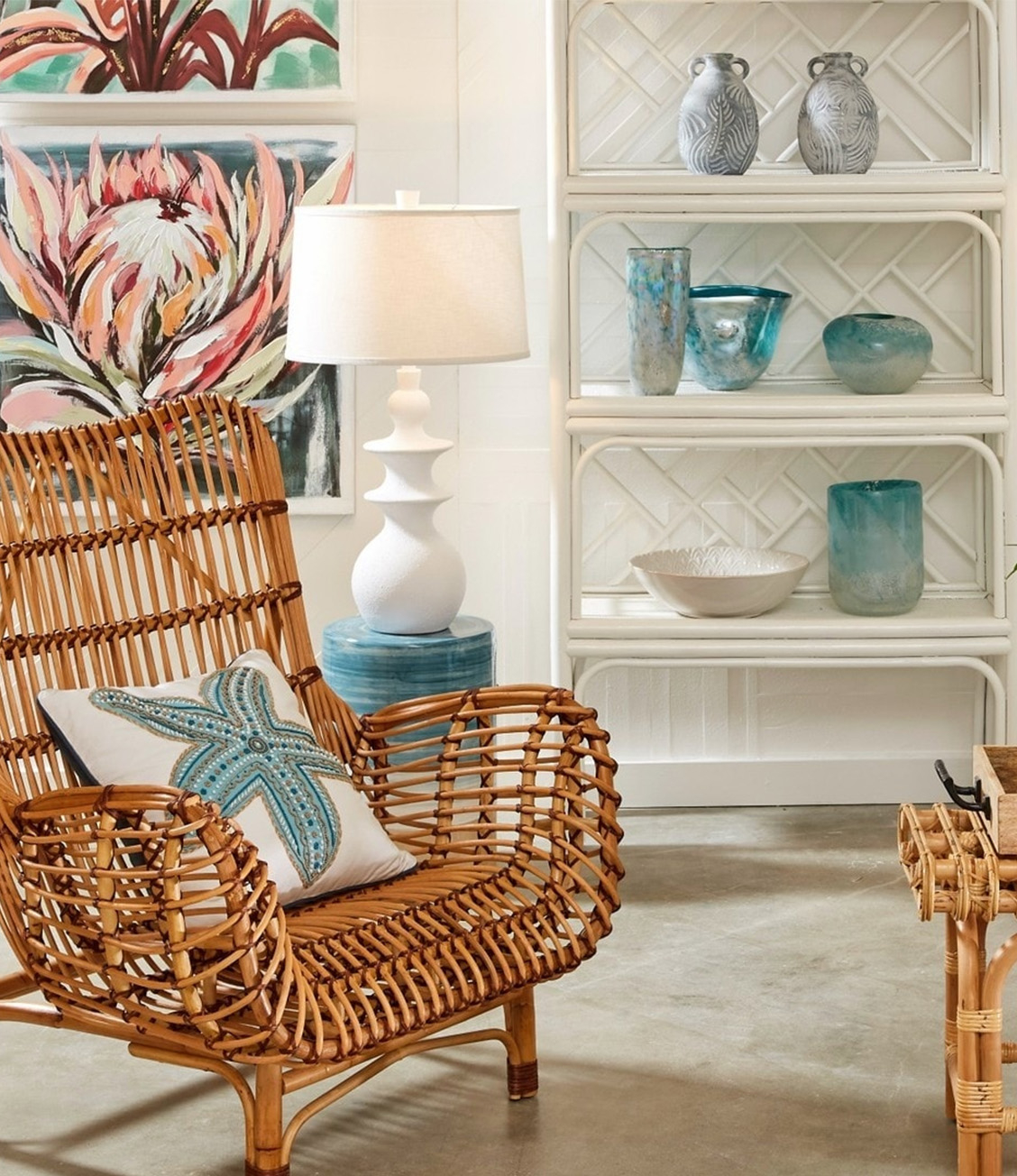 shelf of vessels near table lamp and wood/wicker chair