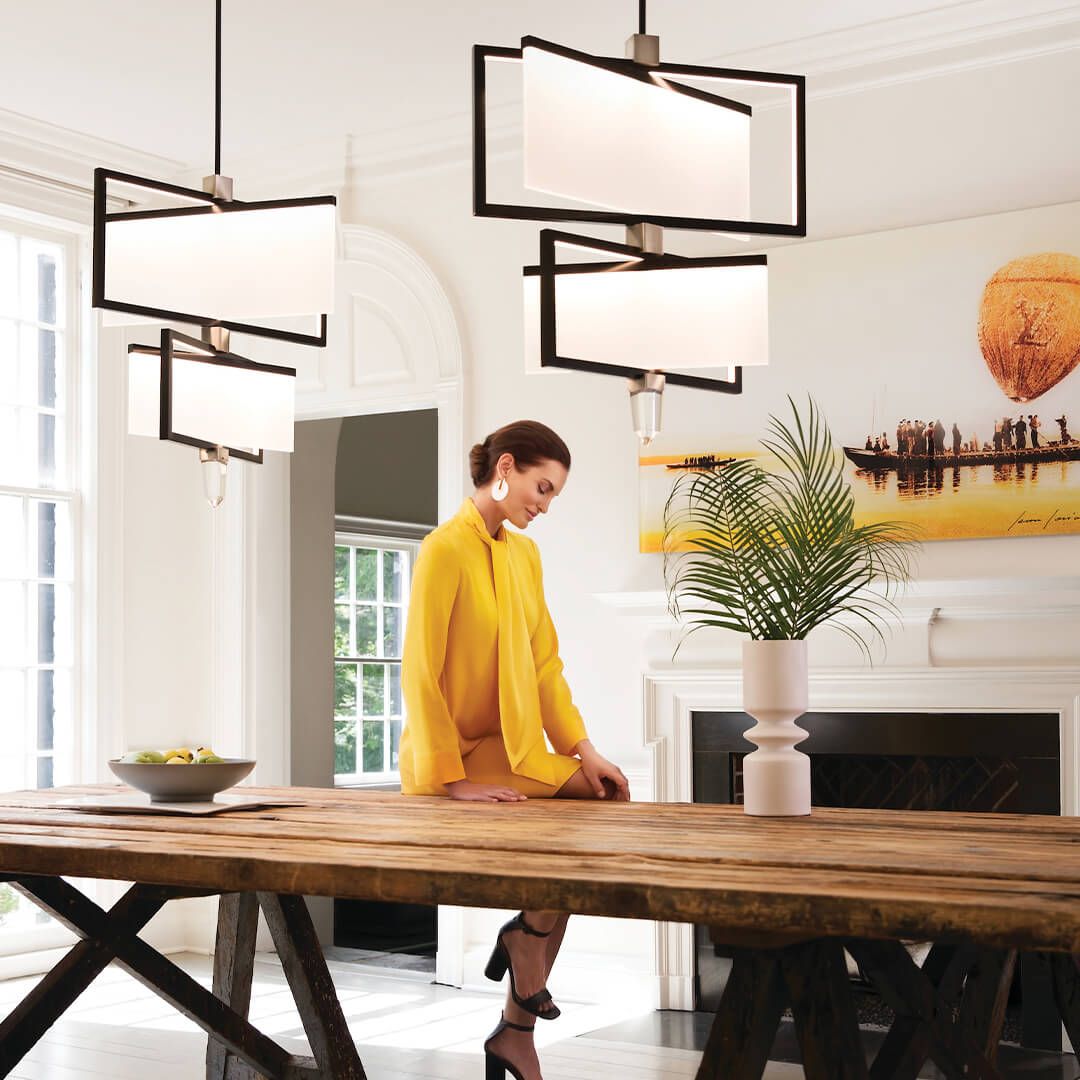 woman under ceiling lights admiring decorations