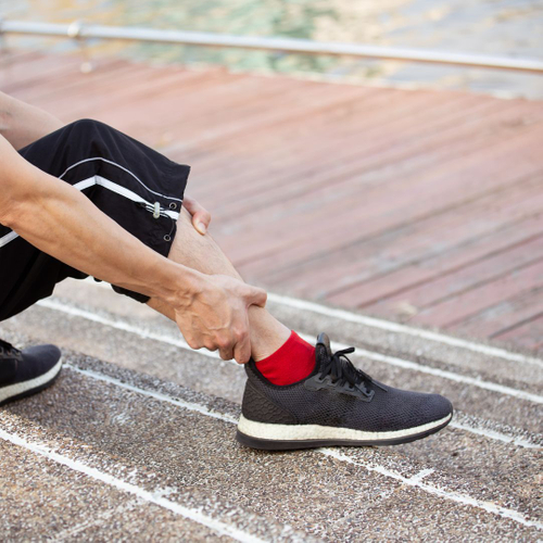 person holding leg after walking