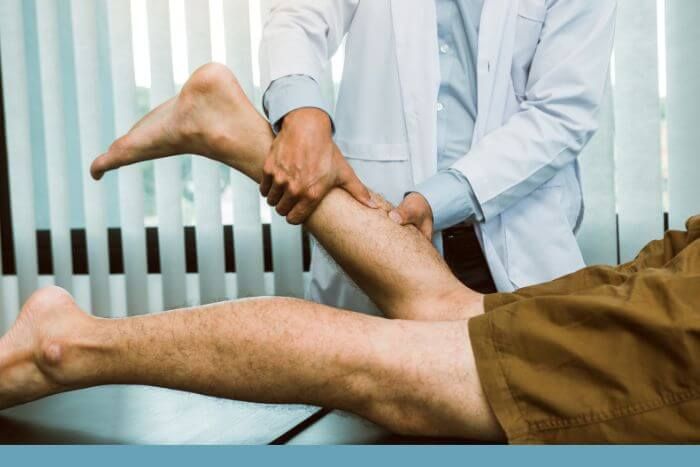 Doctor examining man's leg