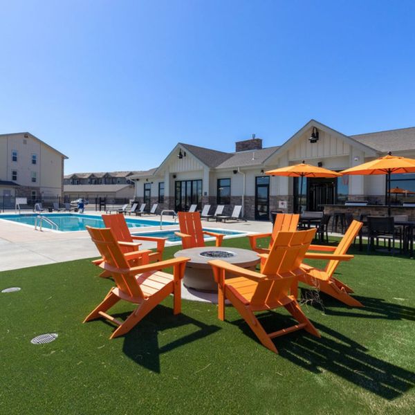a pool and firepit area at an apartment complex