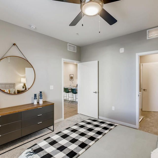 Ten West - Bedroom with Ceiling Fan and Mirror.jpg