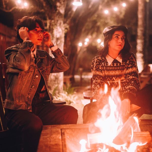 people sitting near fire pit