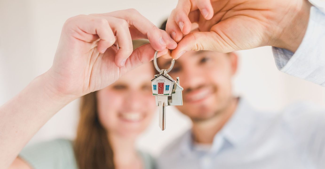 couple holding an apartment key