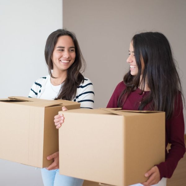 roommates carrying boxes