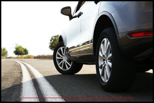 SUV with wheels turned on road Wheel Repair 2 (2).jpg