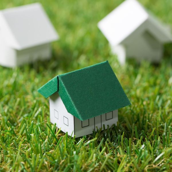 a little toy house with a green roof