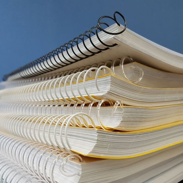 Stack of spiral-bound notebooks on a table