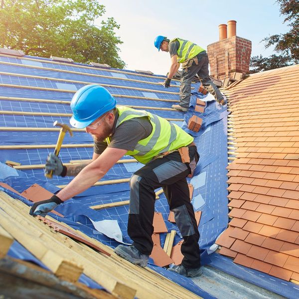 two roofers installing a roof