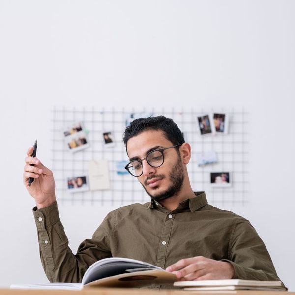 a man looking at a workbook