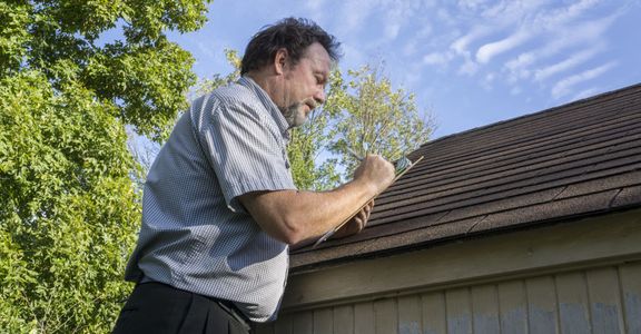 Public adjuster looking at roof damage