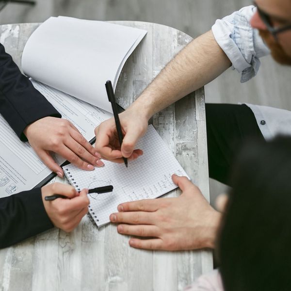 An instructor providing one-on-one feedback to a student preparing for an exam. An instructor providing one-on-one feedback to a student preparing for an exam.