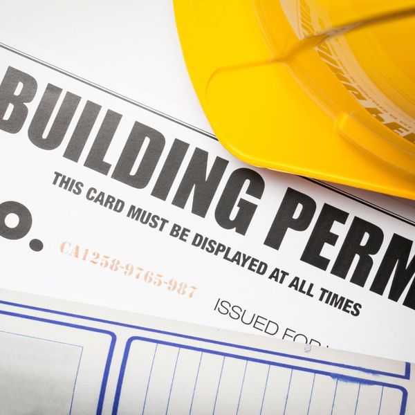 paper that says building permit with a safety hard hat