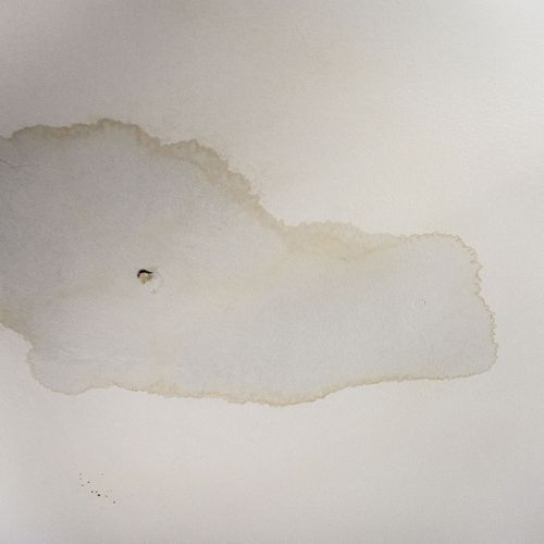 leak in ceiling with a stain