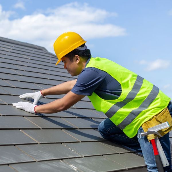 roofer inspecting shingles