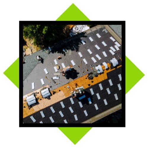 top view of professionals working on commercial roof