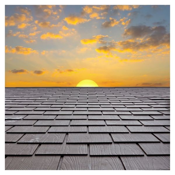 Sunset view over a new, uniform shingle roof installation