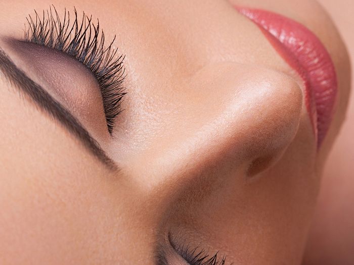 Close-up image of a woman’s face, brows, and lips.