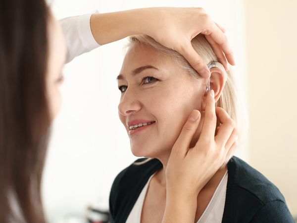 Woman being fitted for hearing aids