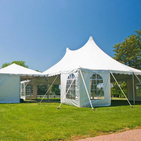 a multi-area party tent outside in the sun