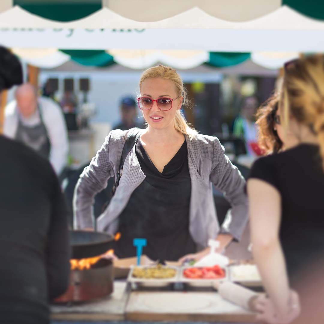 woman looking at food in food tent
