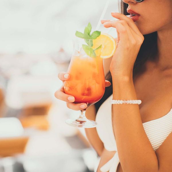 woman sipping cocktail