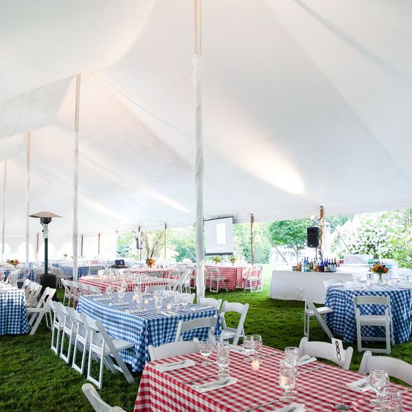 gingham tables under tall event tent