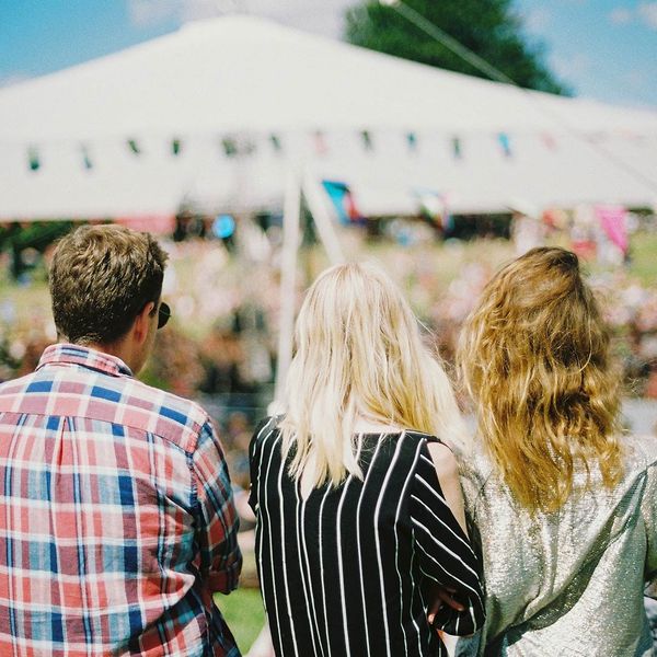 people enjoying the sun with a decorated party tent in the background