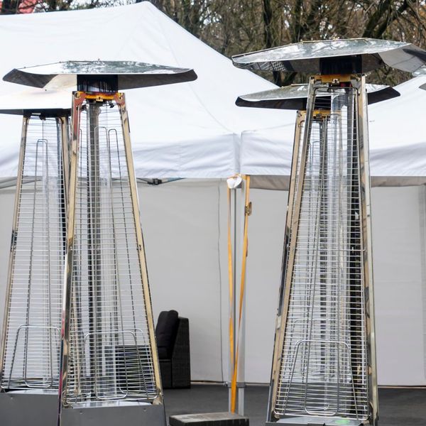 several patio heaters outside tent