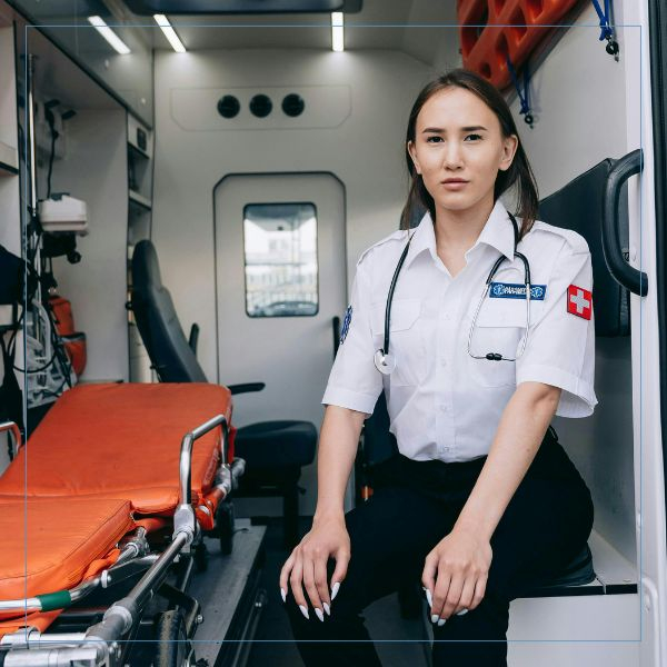 a paramedic sitting in the back of an ambulance Paramedic (3).jpg